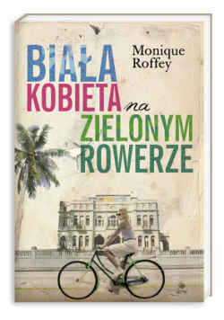 Biała kobieta na zielonym rowerze